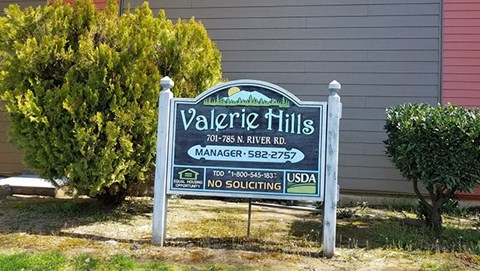 a sign in front of a house
